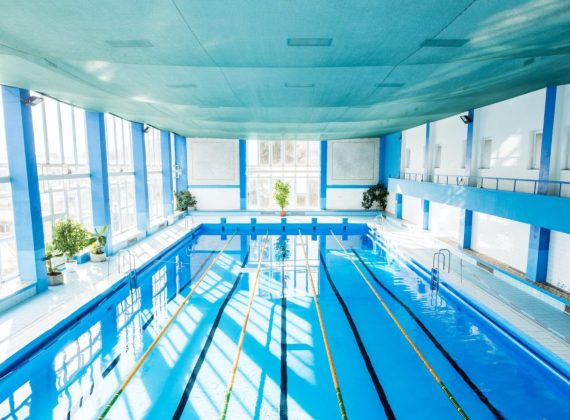 an-interior-of-an-indoor-public-swimming-pool--e1628820244828